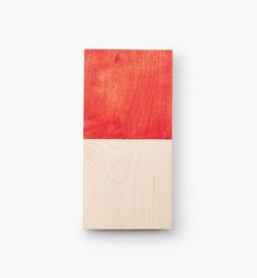 a piece of wood that is red and white