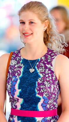 a woman with blonde hair wearing a purple and blue dress