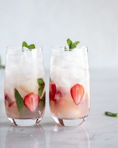 two glasses filled with ice and strawberries