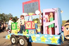 a parade float with people standing on it