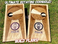 two wooden cornhole boards sitting on top of grass