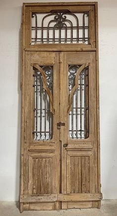 an old wooden double door with glass panels