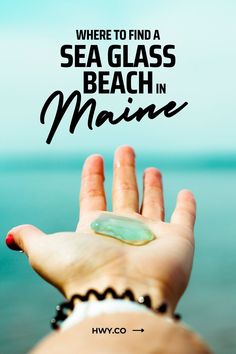 someone holding their hand up to the ocean with text that reads, where to find a sea glass beach in maine