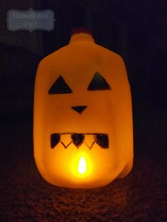 a lighted pumpkin lantern with eyes and teeth