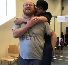 a man and woman hug each other in an office