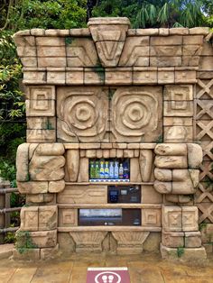 a stone tiki machine in front of some trees