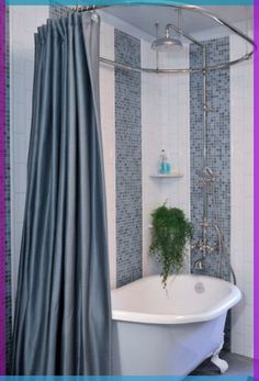 a bath tub sitting next to a shower in a bathroom with blue tiles on the walls