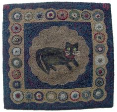 a rug with a black cat on it's back and an oval design in the middle