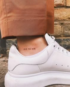 a woman's foot with a small tattoo on her left ankle and the words, we are at me