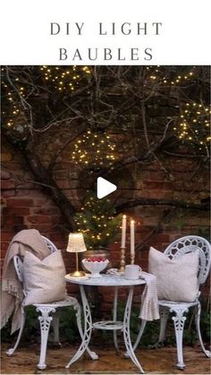 an outdoor table and chairs with lights on the wall in the background, text reads diy light baubles