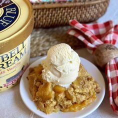 a piece of pie on a plate with ice cream and a basket in the background