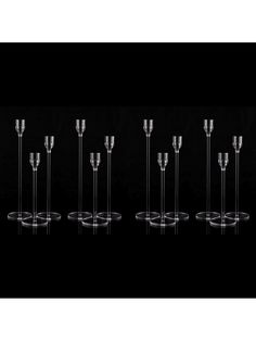 six wine glasses are lined up in a row on a black background, with one empty