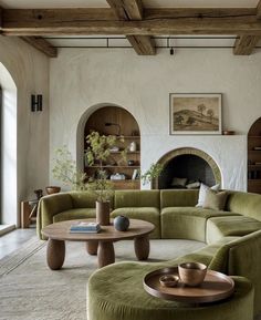 a living room filled with furniture and a fire place in the middle of the room