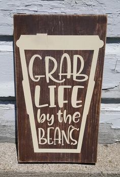 a wooden sign that says crab life by the beans