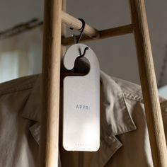 an apple air freshener attached to a wooden ladder with the word appr on it