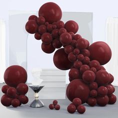 a bunch of red balls floating in the air next to a hourglass and other items