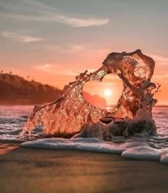 the sun is setting over the ocean and it looks like an object in the water