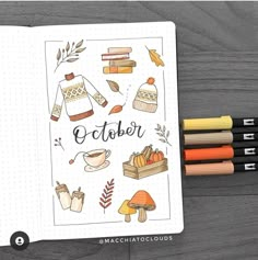 an open notebook with the words october surrounded by autumn related items and crayons