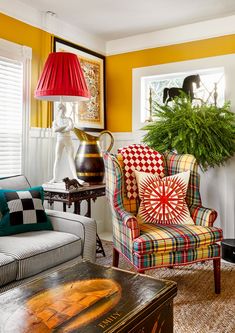 a living room filled with furniture and a potted plant on top of a table