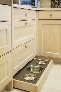 a kitchen with two bowls on the floor