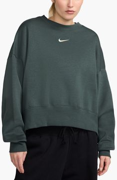 An embroidered Swoosh adds minimal branding to this cozy fleece sweatshirt cut for a relaxed, oversized fit that's enhanced by the dropped shoulders. 22" length (size Medium) Crewneck 80% cotton, 20% polyester Machine wash, tumble dry Imported Nike Phoenix Fleece, Nike Crewneck Sweatshirt, Minimal Branding, Nike Crewneck, Cut Sweatshirts, Fleece Sweatshirt, Christmas List, Oversized Fits, Forest Green