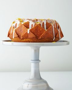 a bundt cake with icing drizzled on top sitting on a plate