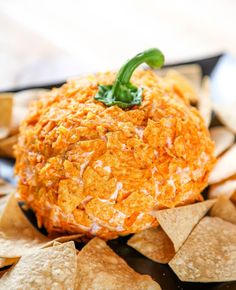 an orange cheese ball surrounded by tortilla chips