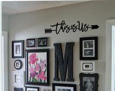 there is a wall with many pictures on it and an arrow above the letter m