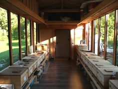 an empty room with lots of boxes on the floor and large windows in front of it