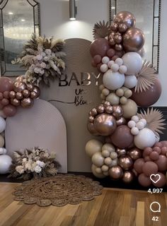 balloons and flowers are arranged in the shape of a letter on top of a chair