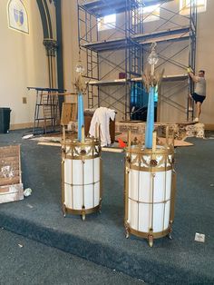 two large white vases sitting on top of a blue carpeted floor next to each other