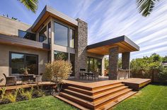 a modern house with wooden steps leading up to it