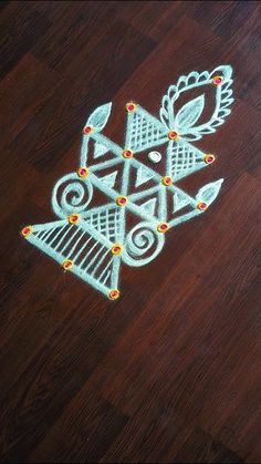 an intricately designed design on the floor in front of a wooden table with lights