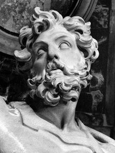 a statue of a man with curly hair and beard