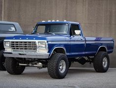 a blue truck parked in front of a building