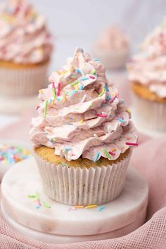 cupcakes with pink frosting and sprinkles on top