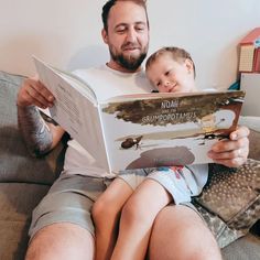 a man reading a book to his son