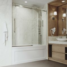 a bathroom with marble counter tops and wooden cabinetry, along with a walk in shower