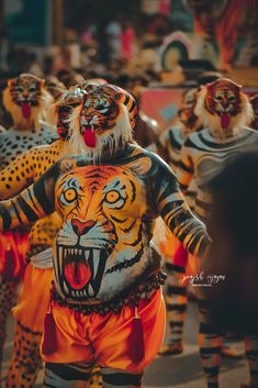 a group of people with painted tigers on their body