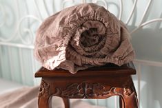 a piece of cloth sitting on top of a wooden chair