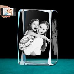 a glass photo frame with a woman holding a child