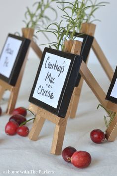 three small wooden easers holding cherries on top of a table