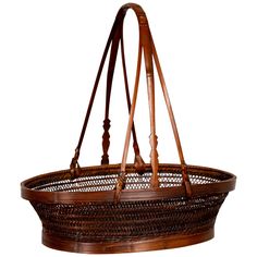 a basket hanging from the ceiling with leather straps on it's ends and handles