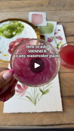 someone is holding a wine glass with the words how to add shimmy to any watercolor paint