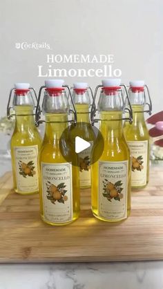 six bottles of lemonade sit on a cutting board