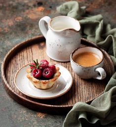 two cups and a plate with some food on it