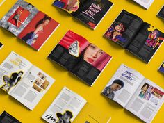 an assortment of magazine pages spread out on a yellow surface with black and white images