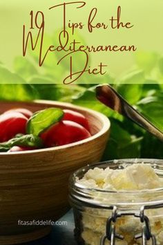 a wooden bowl filled with food next to a glass jar full of rice and tomatoes