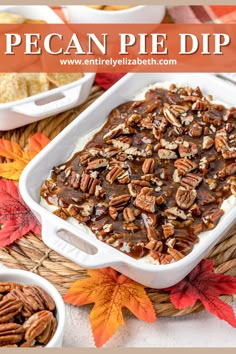 pecan pie dip in a white casserole dish surrounded by fall leaves and candies