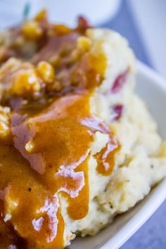 mashed potatoes covered in gravy on a plate